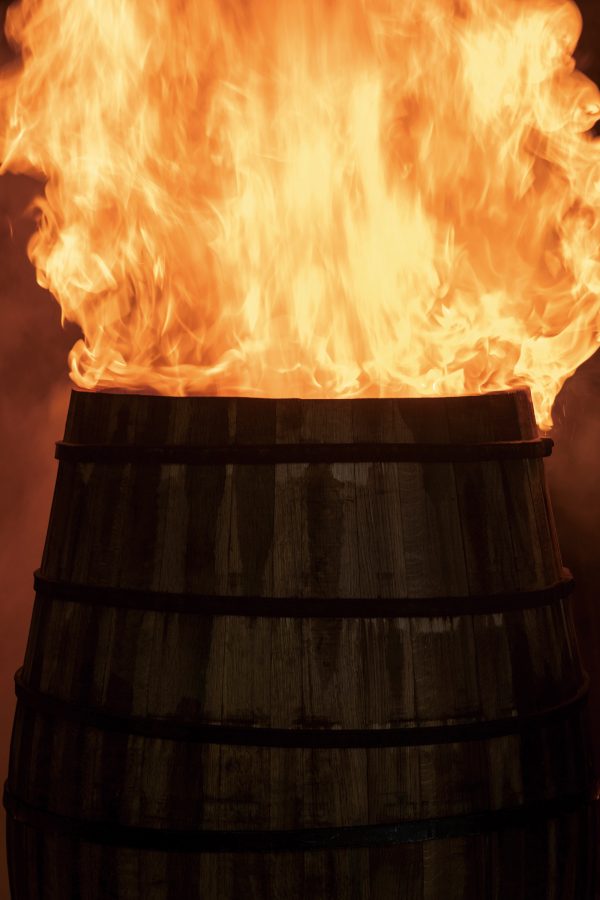 Fire erupting from a wooden barrel. 