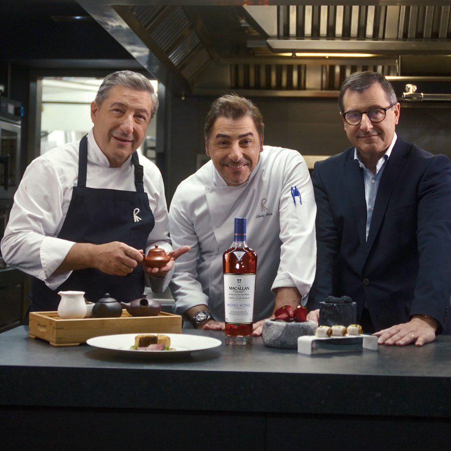 The Roca brothers (from the left) Joan, Jordi and Josep standing over a spread of canapes, tea and whisky