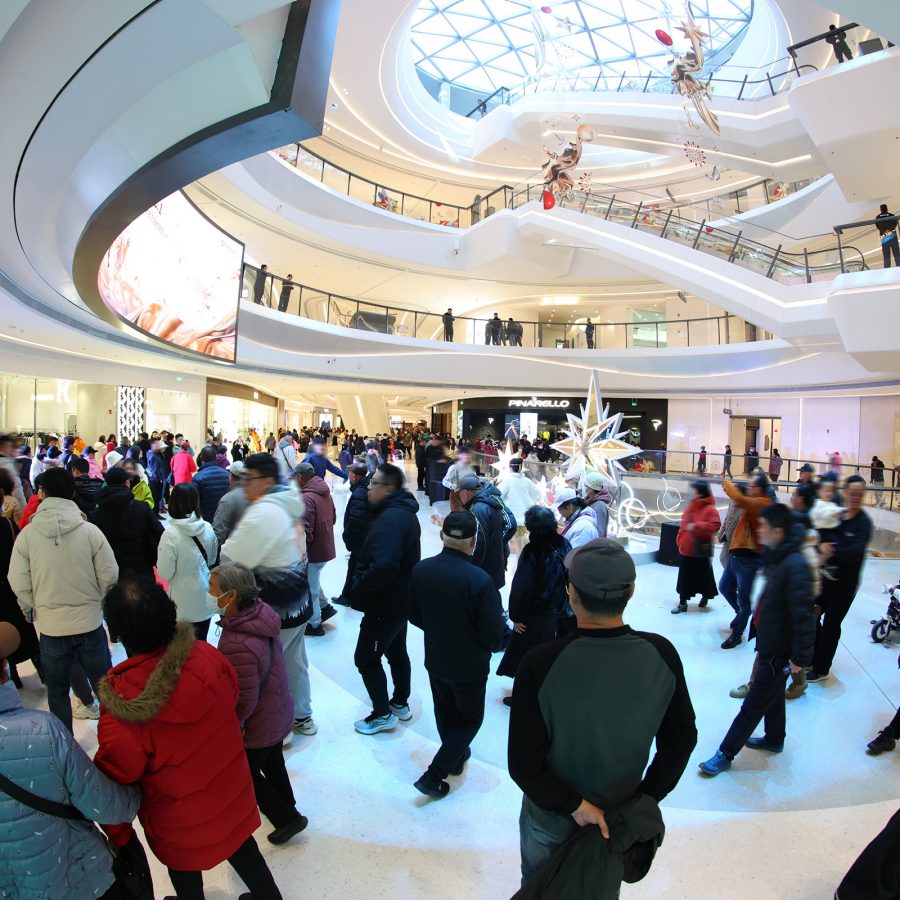 Interior view of shoppers inside GT Plaza Qingdao shopping mall.  