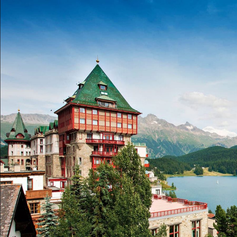 Exterior view of Badrutt’s Palace, St Moritz, Switzerland, with mountains in the background