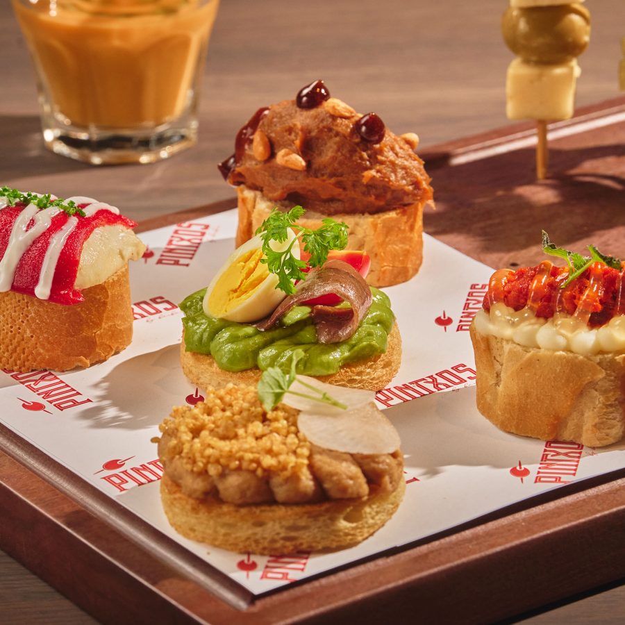 Small savoury bites from Pintxos by Bàrbar are arranged on a platter.