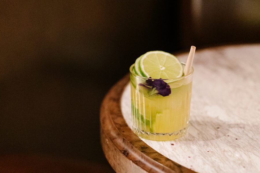 A refreshingly yellow drink sits on the edge of a table at Perfume Trees Gin by Tankyu Distillery. 