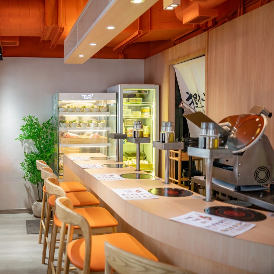 The interior of Tanukikoji features bar seating and is clean looking. 
