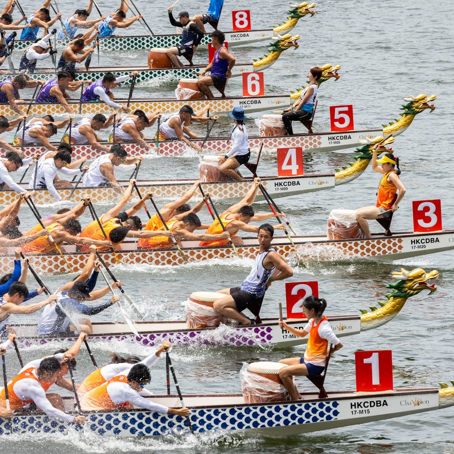 Rows of dragon boats racing across the water.