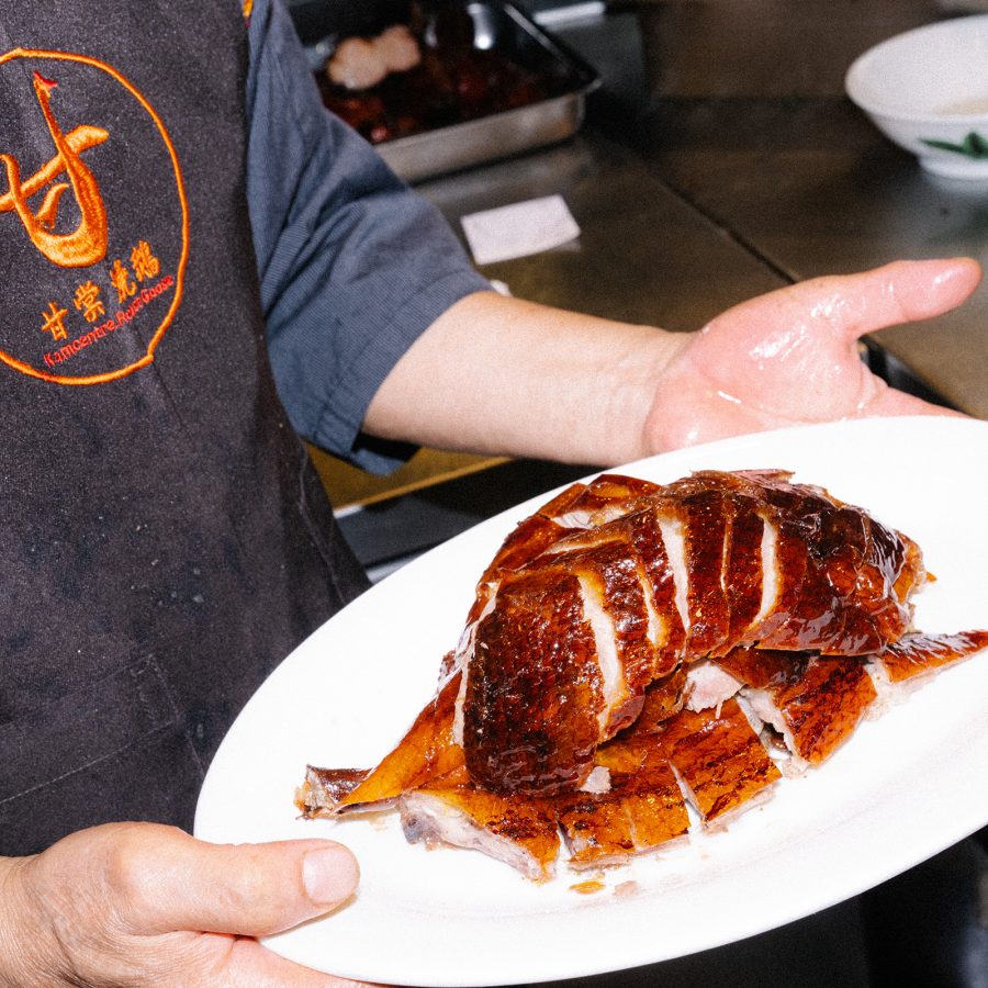 Chef serving a platter of roast goose.