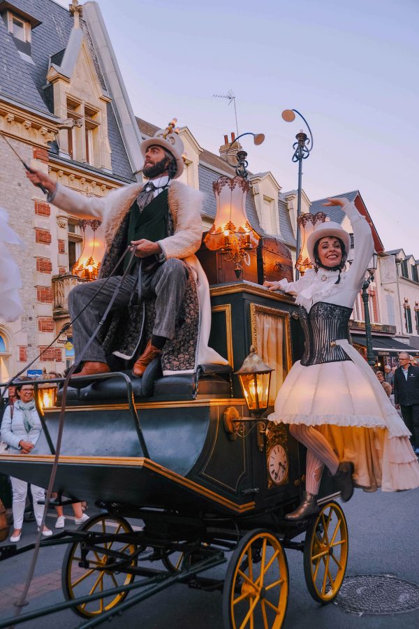 Performers wave to crowds as part of the Le Bal parade.