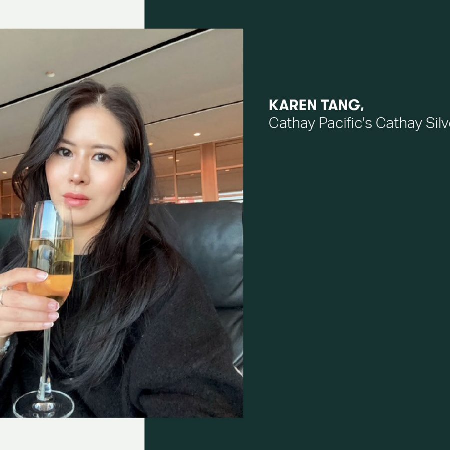 Cathay Pacific's Cathay Silver Member Karen Tang holding a glass of champagne in the Cathay lounge