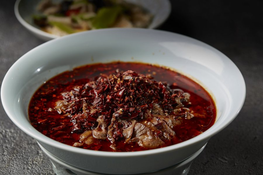 A closeup of braised angus beef in red chili broth served in Deng G in Tsim Sha Tsui, Hong Kong.