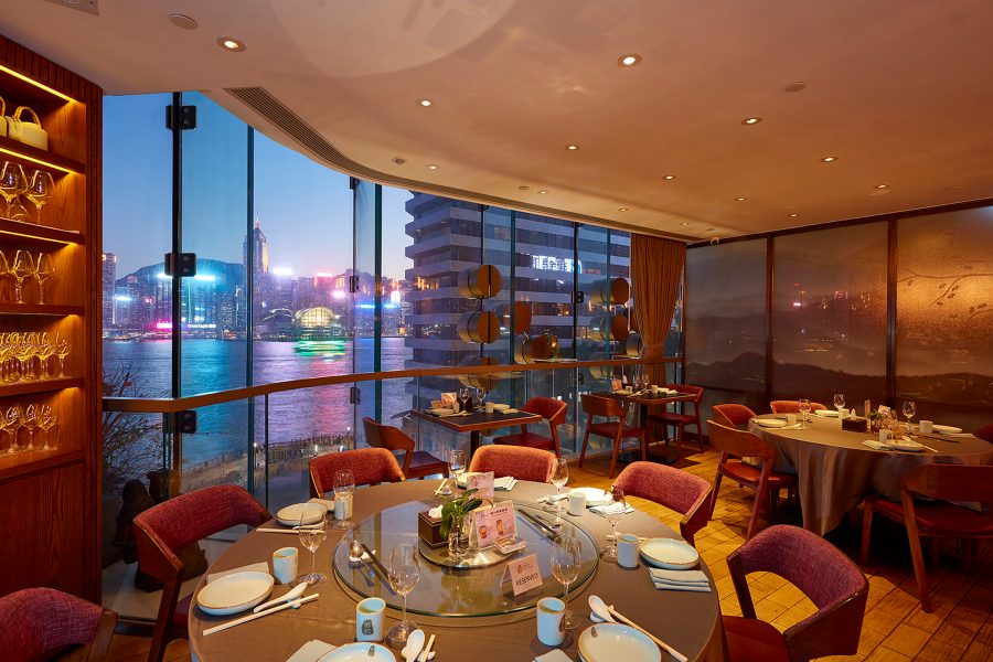 Interior view of Deng G dining area with views of Victoria Harbour in Tsim Sha Tsui, Hong Kong.