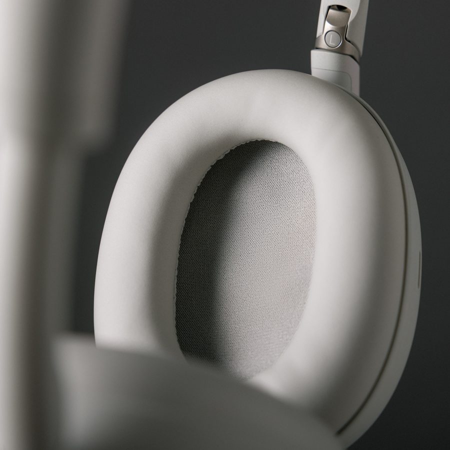 Close-up of an earcup on a pair of Sony WH-1000XM6 headphones in platinum silver.