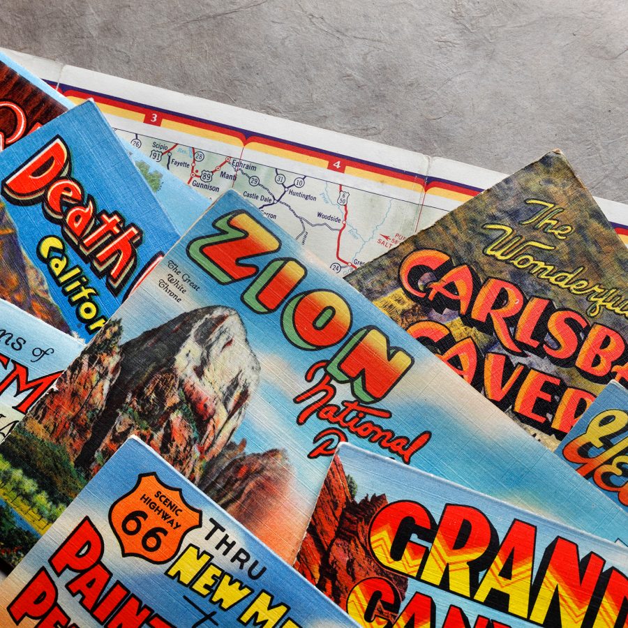 Stacks of travel pamphlets on top of a road map.  