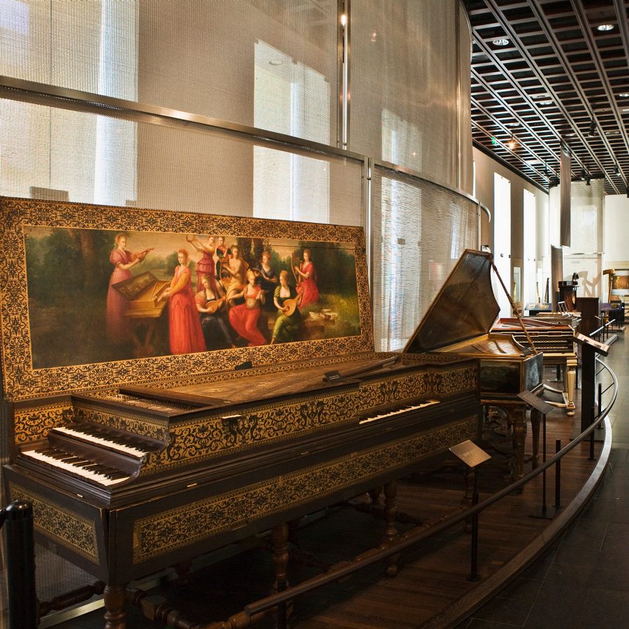 The interior of a museum in Brussels shows historical artefacts lining a hallway. 