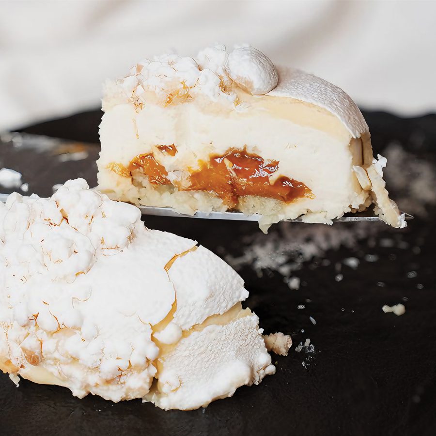 A white dessert is cut in half to reveal a caramel-coloured center at Nativa.
