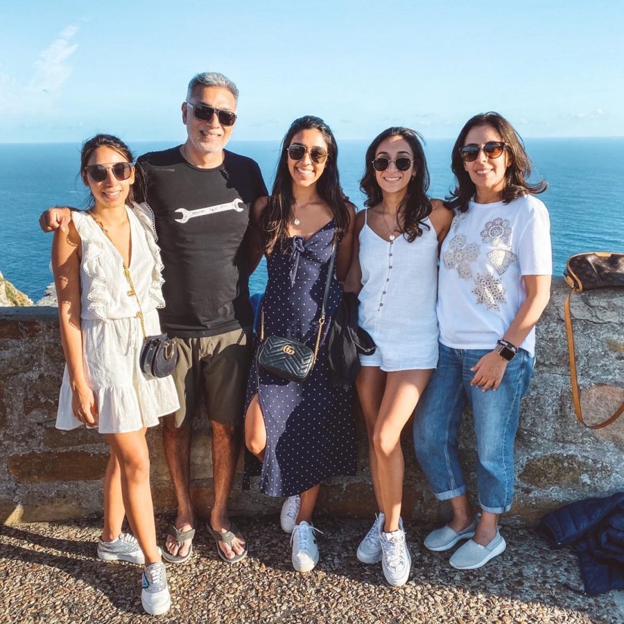 Vijay, his wife and his three daughters smiling by the sea in Cape Town. 