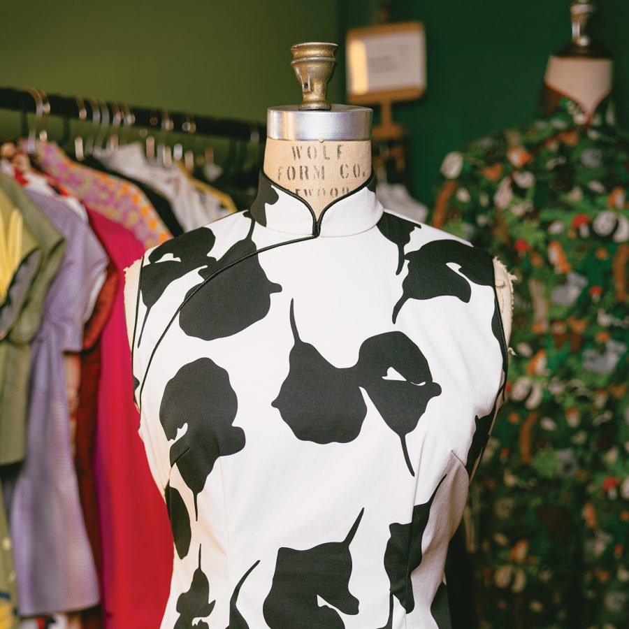 A black-and-white patterned cheongsam is displayed on a mannequin.