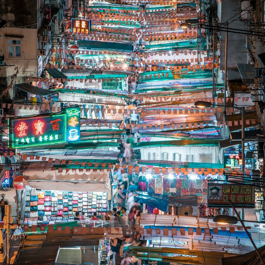 Ladies’ Market seen from above is a condensed street of lit up stalls separated by tarp sheets. 