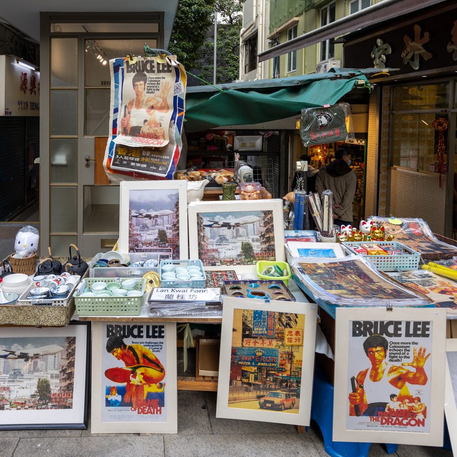 A streetside stall sells prints of Bruce Lee.