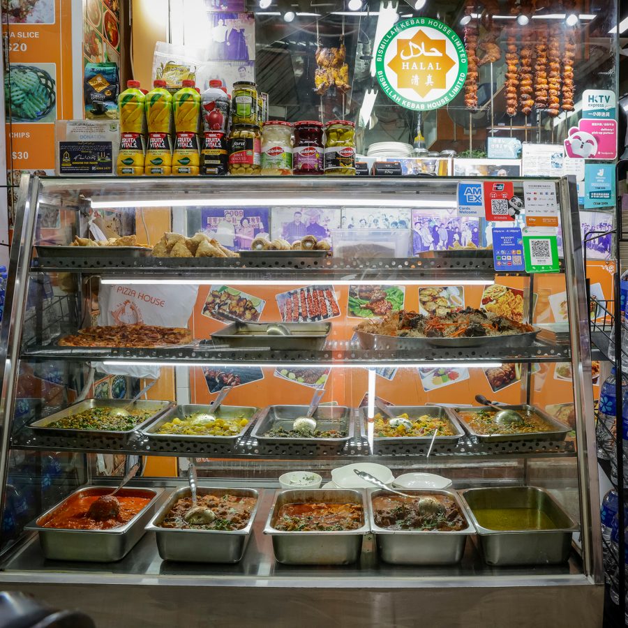 A shop inside Chungking Mansions sells food, shown behind a glass display. 