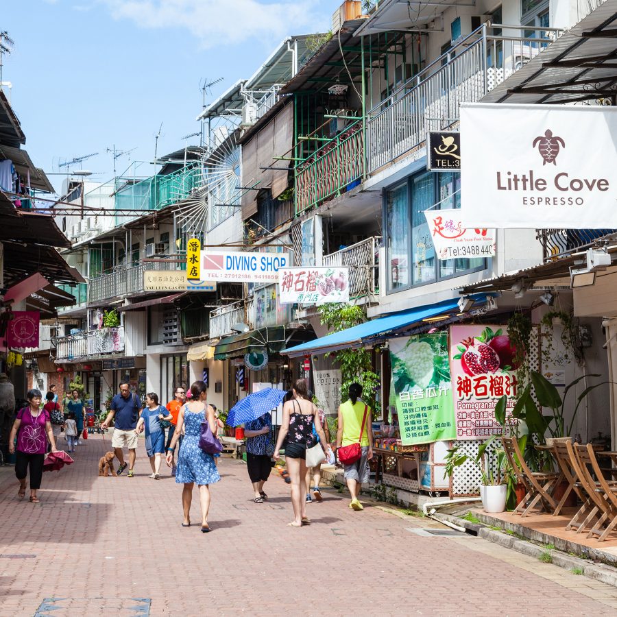 People walk in the narrow streets of Sai Kung. 