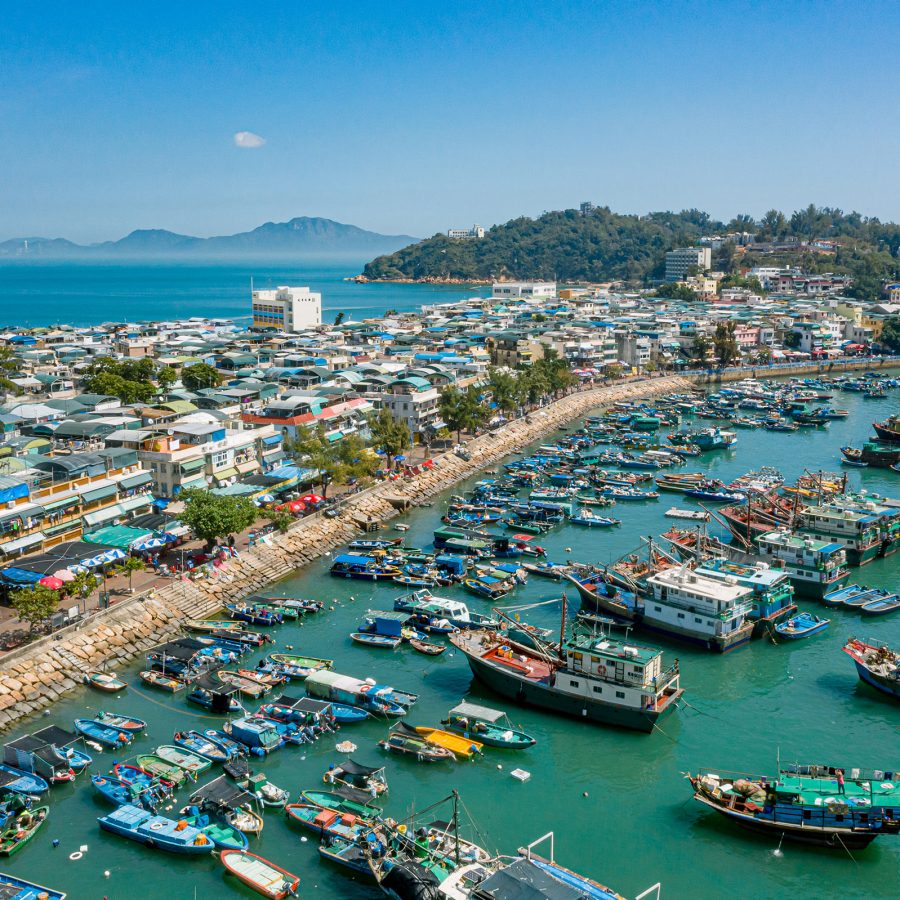 A view of Cheung Chau from above reveals boats sitting along a narrow jetty. 