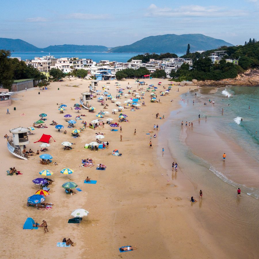 People set up umbrellas along Big Wave Bay Beach.  