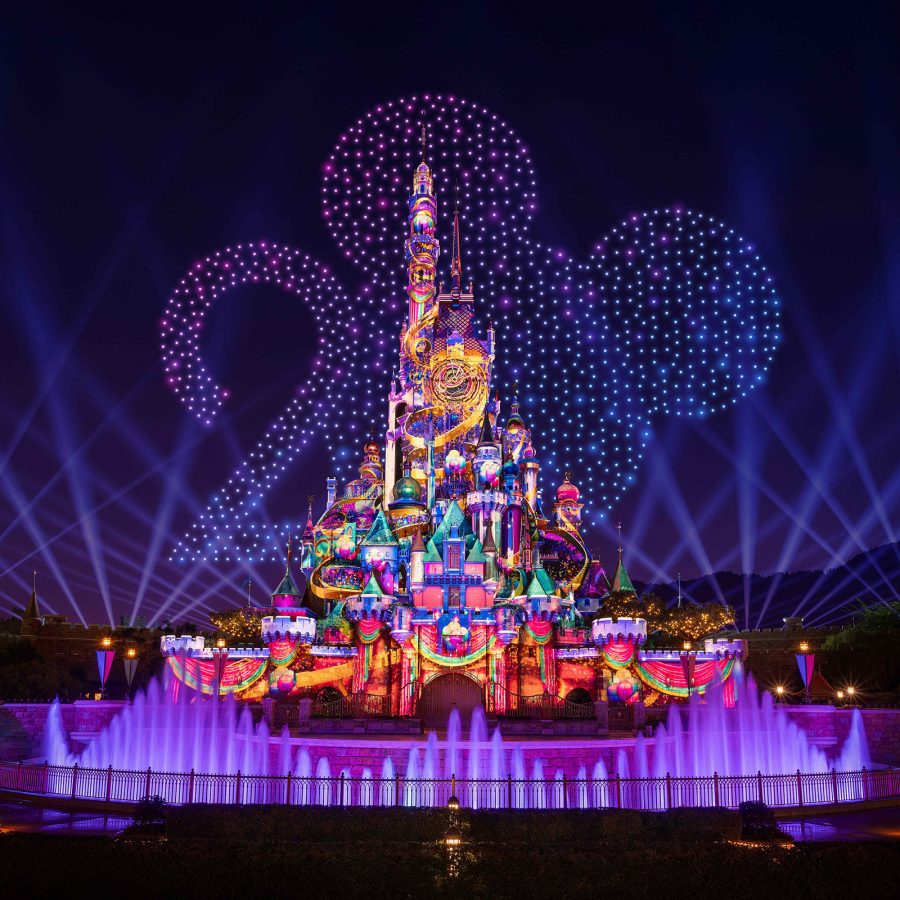 Disneyland’s castle is aglow during a night time show. 