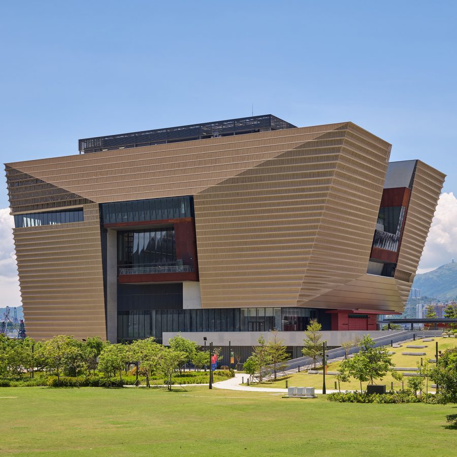 Hong Kong Palace Museum sits on top of a green field. 