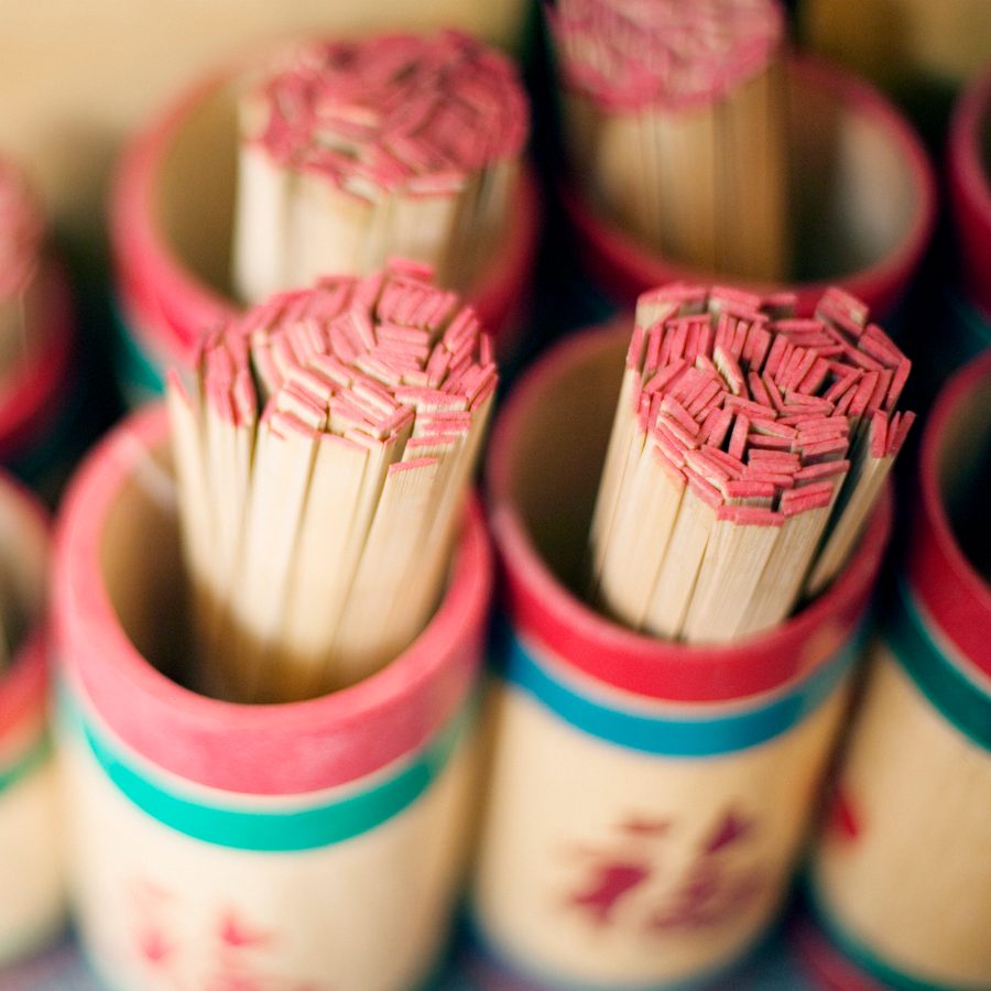 Containers of bamboo sticks are placed aside for fortune telling. 