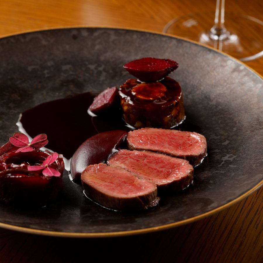 A plate of cooked meat is placed on a table.