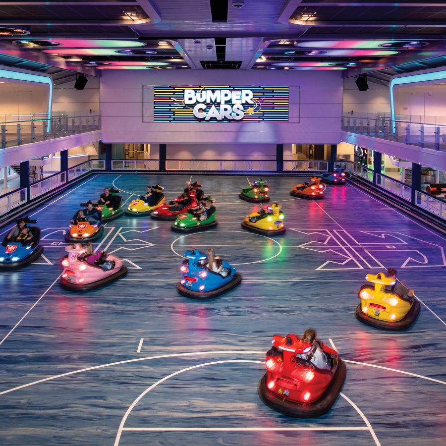 People playing on colourful bumper cars.