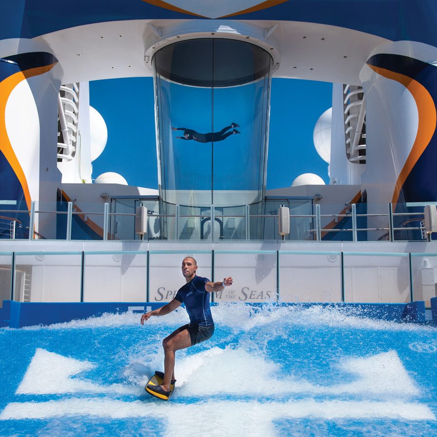 A man riding a wave on a FlowRider surf simulator.