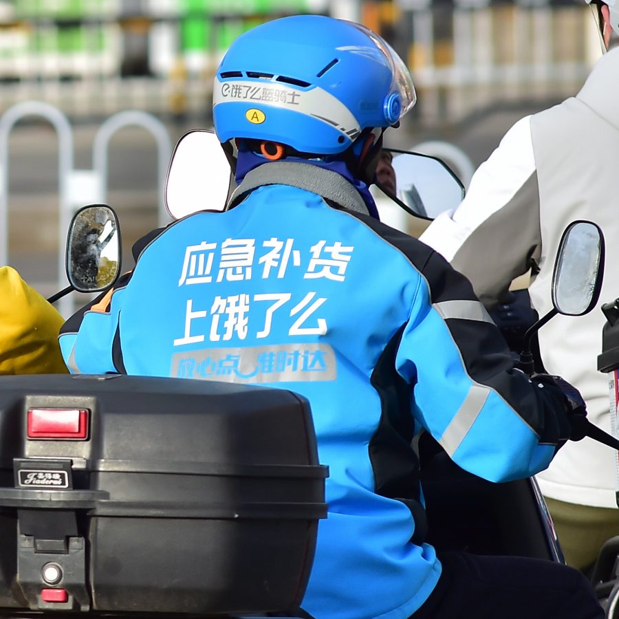 Chinese food delivery drivers on motorcycles.