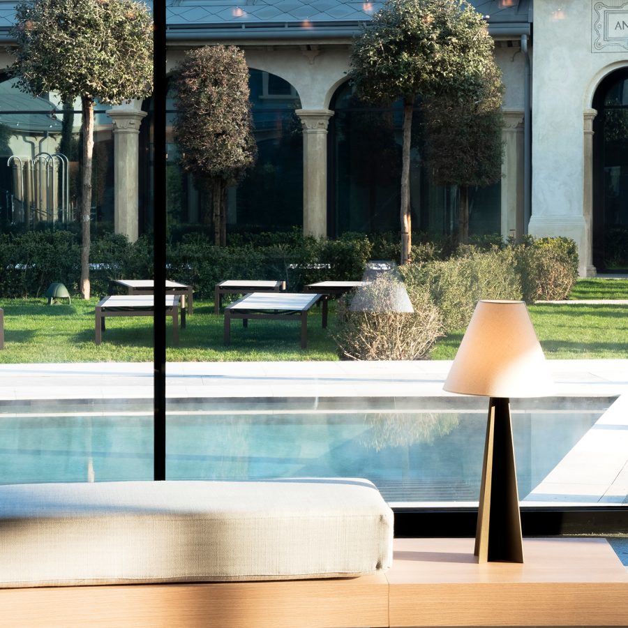 De Montel – Terme Milano’s outdoor pool is visible from an indoor treatment room.