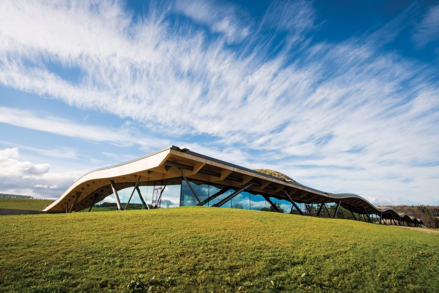 View of The Macallan Estate with blue sunny skies above it. 