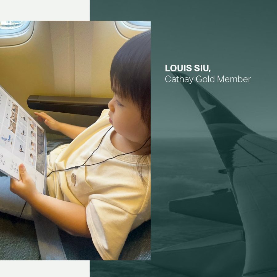 A young girl reading the safety manual on a plane.
