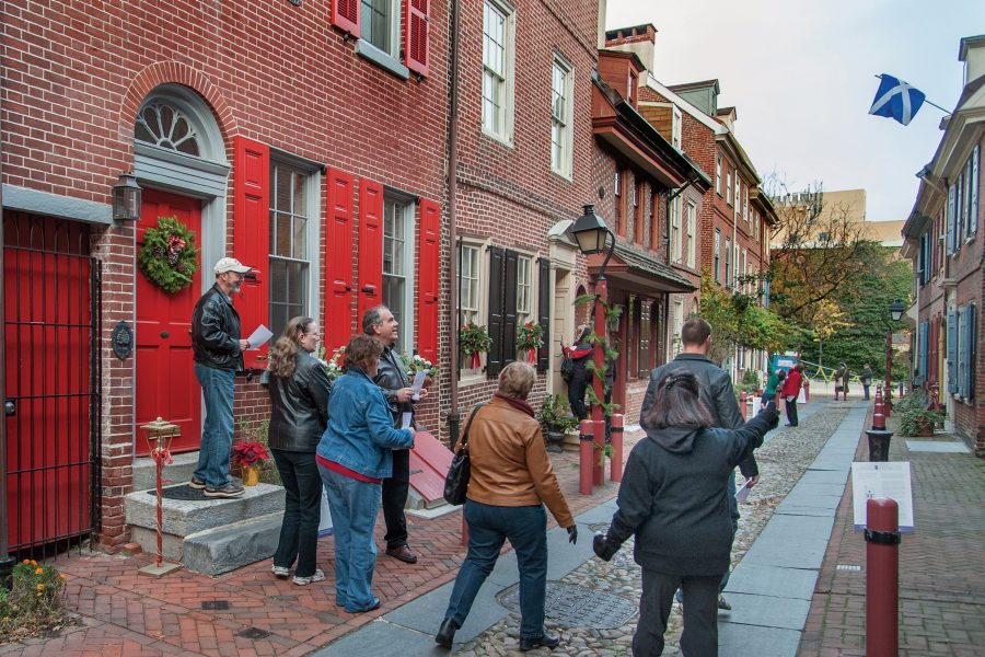 Exterior view of a group of tourists on a walking tour of the historic Elfreth’s Alley