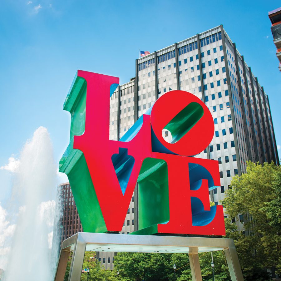 An iconic red, blue and green sculpture of the letters LOVE in JFK Plaza.