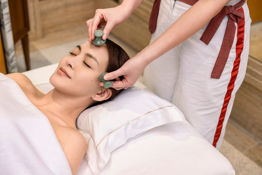 A woman enjoying the Silky Glow Facial at Asaya Spa by Guerlain.