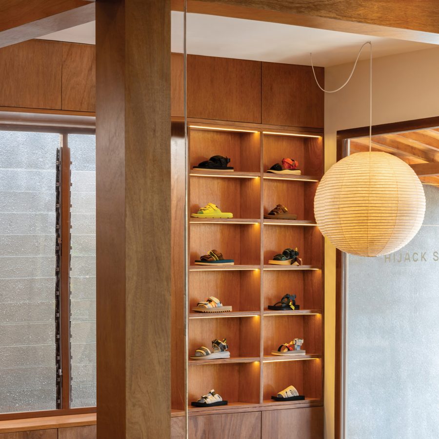 A range of sandals are on display inside wooden cubbies at Hijack Sandals.
