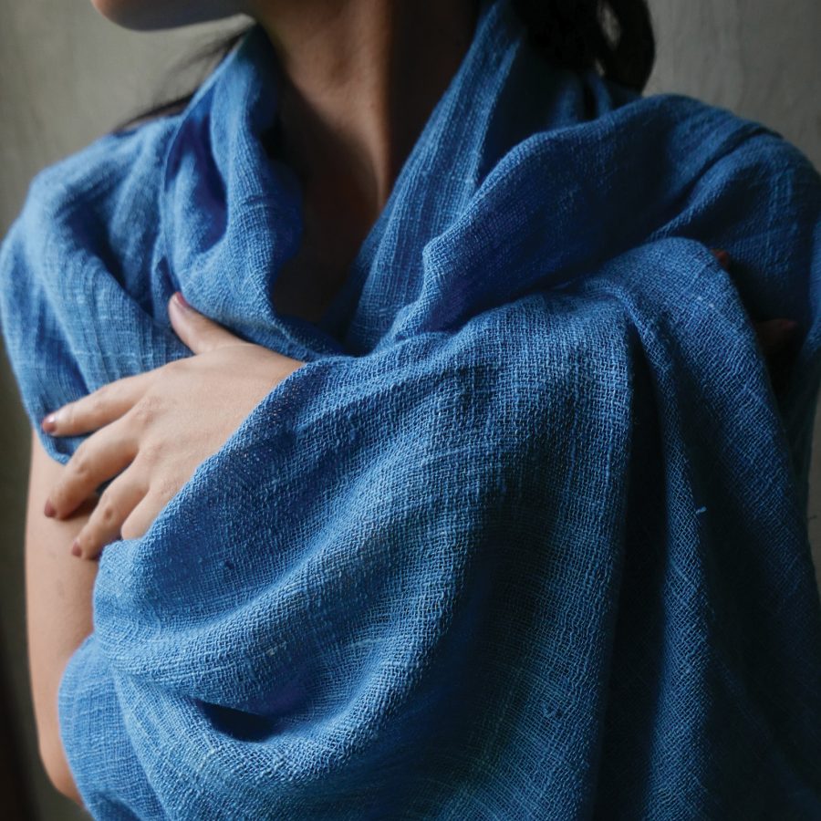 A model is wrapped with blue fabric from Threads of Life.
