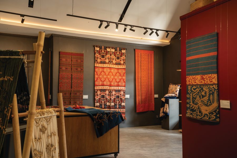 The interior of Threads of Life, Bali showcases patterned cloth and fabrics on its walls.