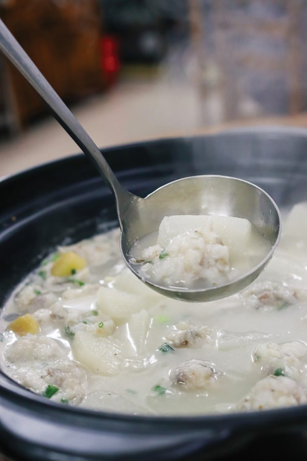A close-up view of a ladle in a rice dish