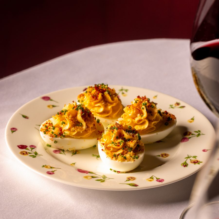 Four devilled eggs sit on a floral plate at Jean-Pierre in Hong Kong.