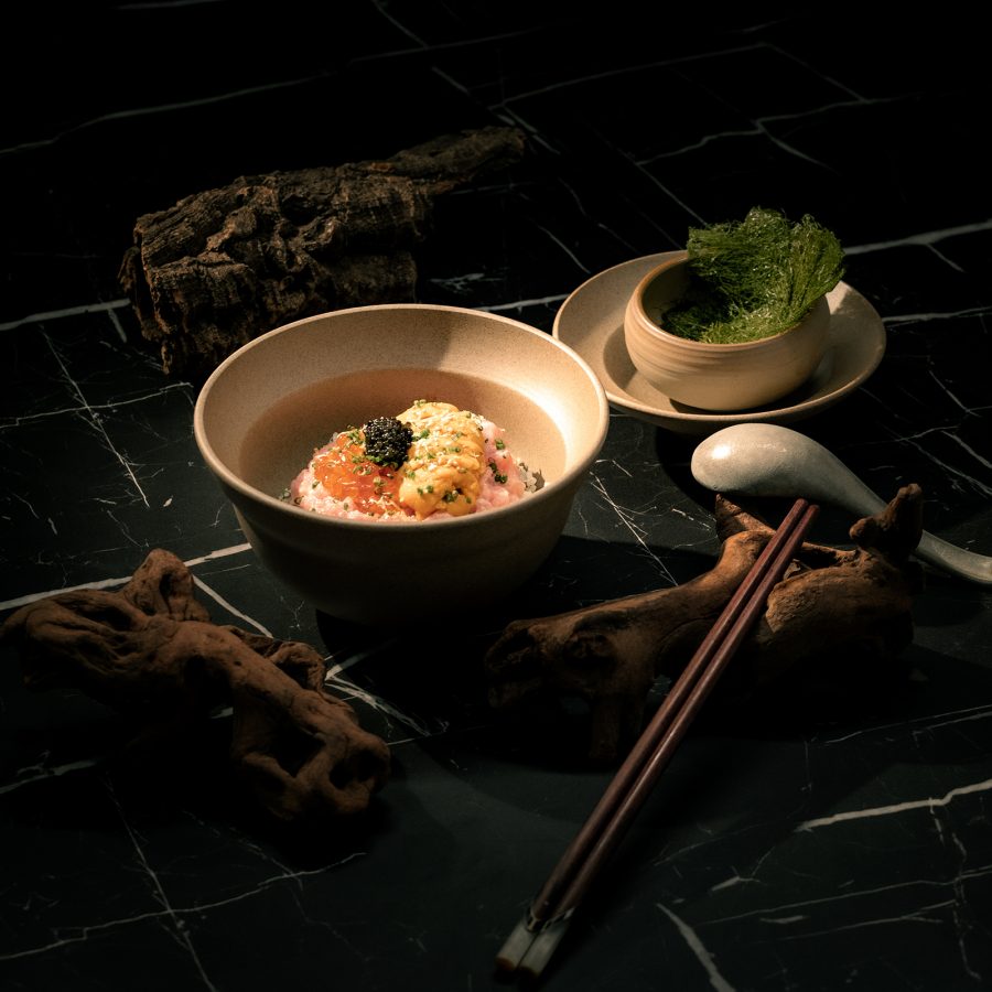 Light shines on a dish topped with uni in Yorucho in Hong Kong.