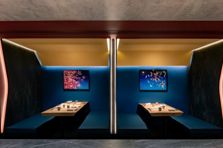 Side view of two intimate blue dining pods at Yorucho in Hong Kong.
