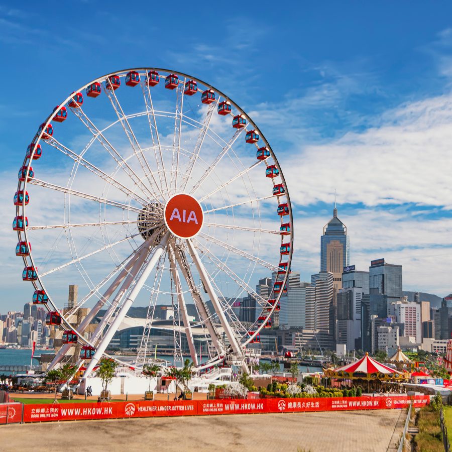AIA ferris wheel on Hong Kong harbourfront during a sunny day.