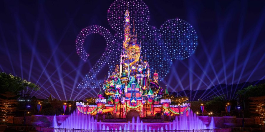 Fireworks shaped like Mickey Mouse and the number 20 shine over the Hong Kong Disneyland castle.