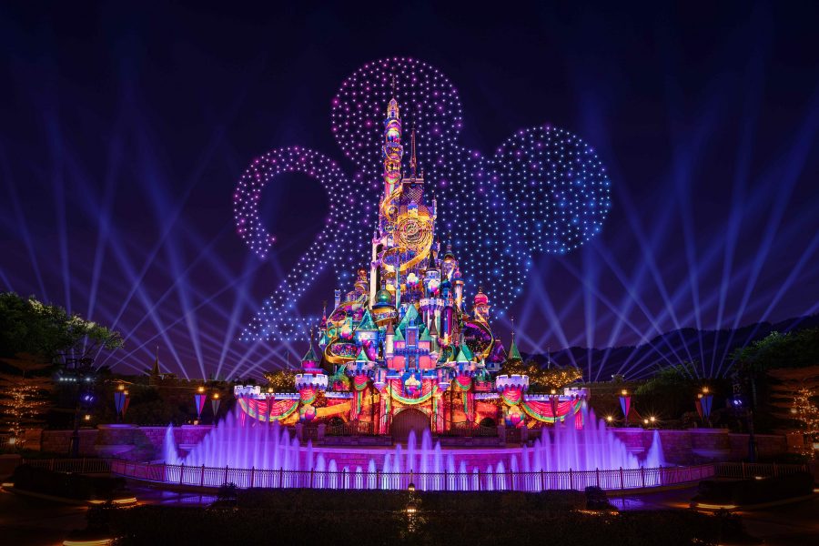 Fireworks shaped like Mickey Mouse and the number 20 shine over the Hong Kong Disneyland castle.