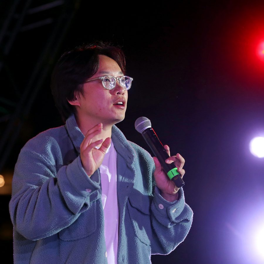 Comedian Jimmy O. Yang speaks into a microphone onstage.