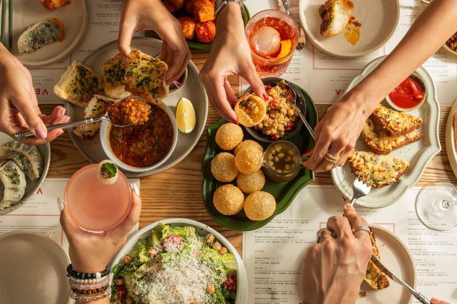 A flat lay family spread of modern Indian vegetarian dishes at Veda.